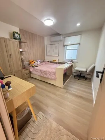 a spacious bedroom with a bed and a flat screen tv