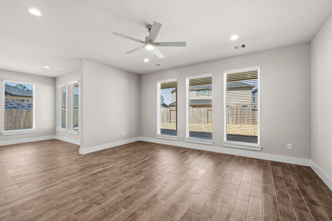 2137 Golden Spruce Court Conroe, TX 77301 - Photo 11 of 41 a view of an empty room with wooden floor and a window