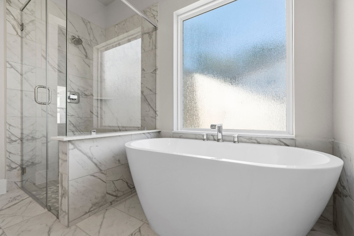 2137 Golden Spruce Court Conroe, TX 77301 - Photo 16 of 41 a white bath tub sitting in a bathroom next to a window