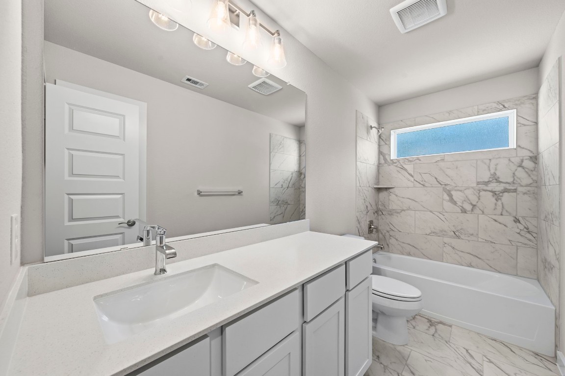 2137 Golden Spruce Court Conroe, TX 77301 - Photo 23 of 41 a bathroom with a sink a toilet and shower