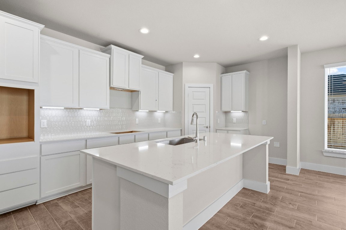 2137 Golden Spruce Court Conroe, TX 77301 - Photo 3 of 41 a kitchen with white cabinets appliances a sink and a window