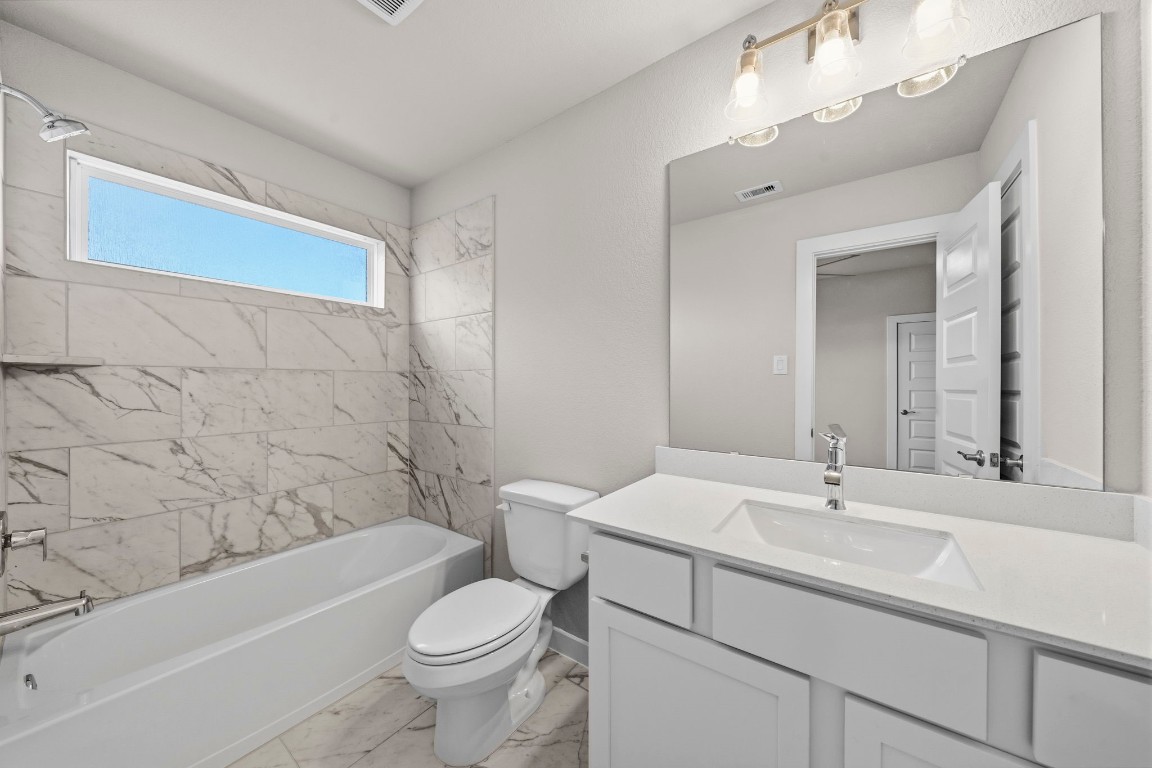 2137 Golden Spruce Court Conroe, TX 77301 - Photo 31 of 41 a bathroom with a sink a toilet and a bathtub