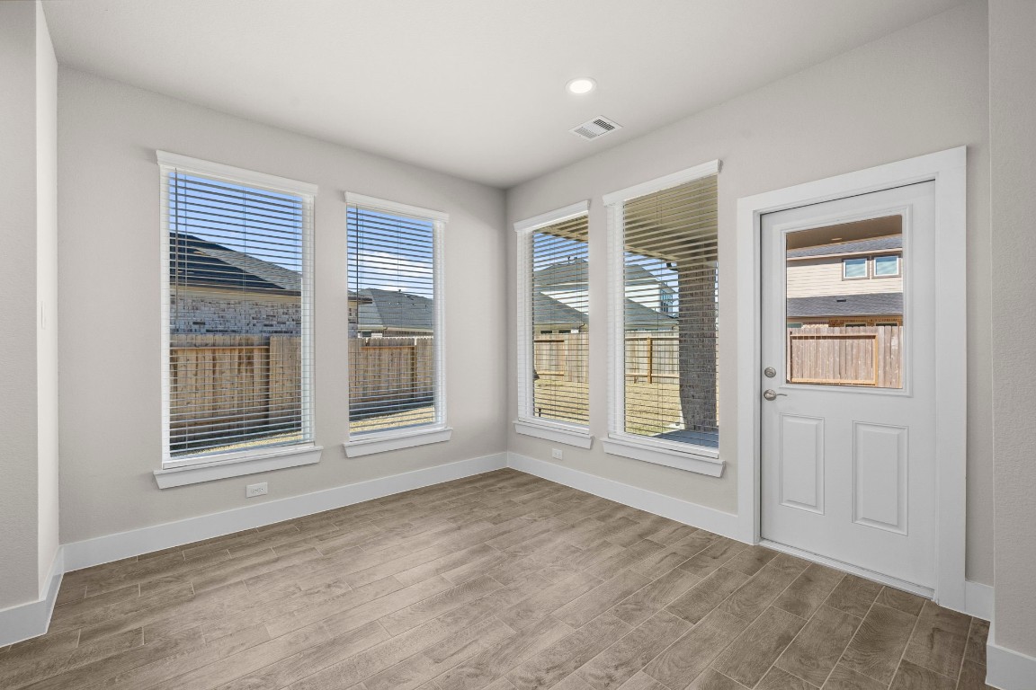 2137 Golden Spruce Court Conroe, TX 77301 - Photo 8 of 41 a view of an empty room with a window and wooden floor