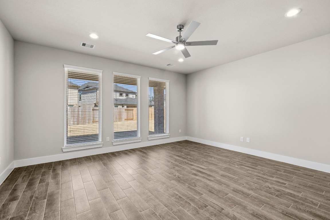 2137 Golden Spruce Court Conroe, TX 77301 - Photo 9 of 41 wooden floor in an empty room with a window