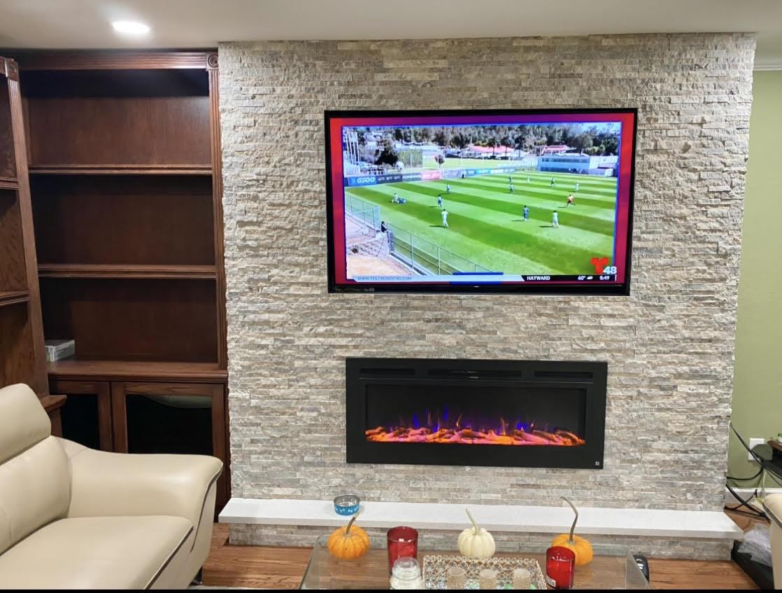 3223 Spring Street Redwood City, CA 94063 - Photo 3 of 10 a living room with a fireplace and a flat screen tv