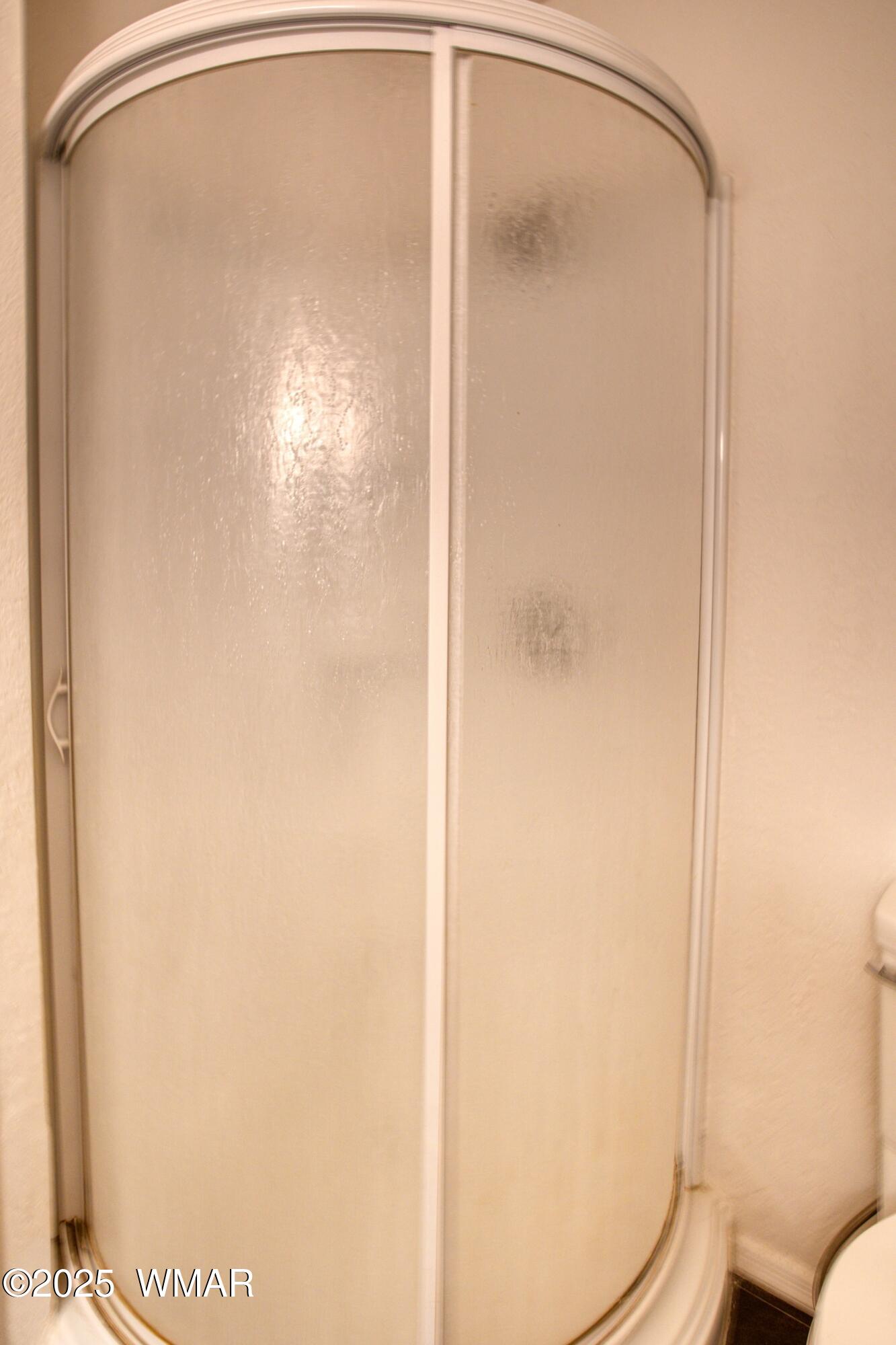2700 South White Mountain Road, Unit 122 Show Low, AZ 85901 - Photo 14 of 25 a bathroom with a glass shower door
