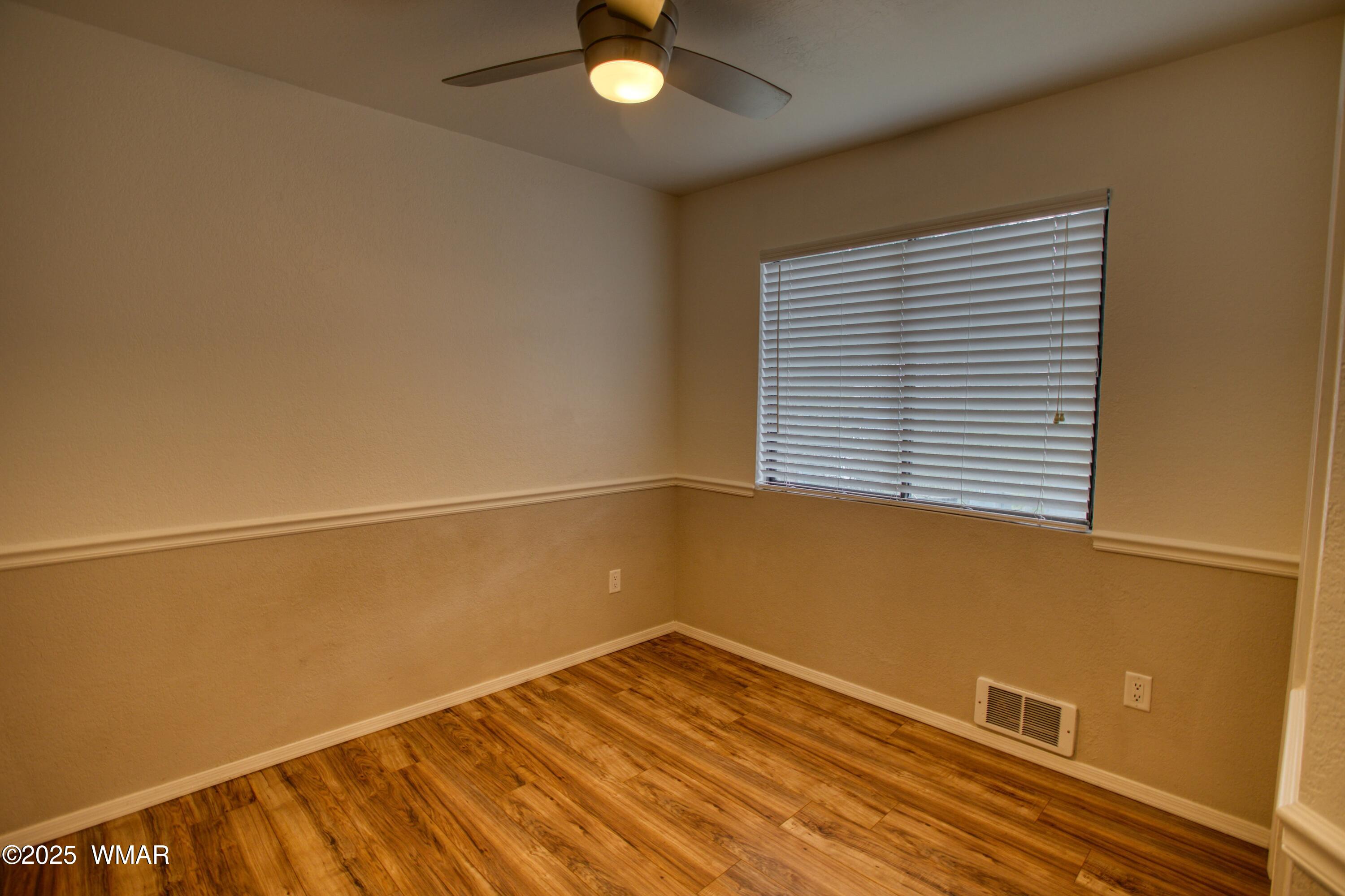 2700 South White Mountain Road, Unit 122 Show Low, AZ 85901 - Photo 15 of 25 a view of a room with a window and wooden floor