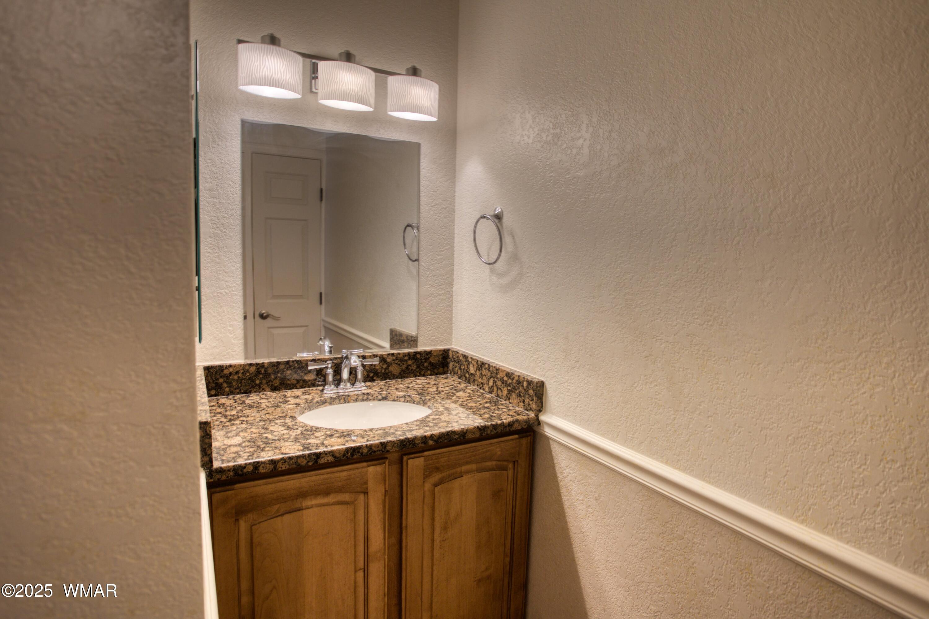 2700 South White Mountain Road, Unit 122 Show Low, AZ 85901 - Photo 16 of 25 a bathroom with a granite countertop sink and a mirror