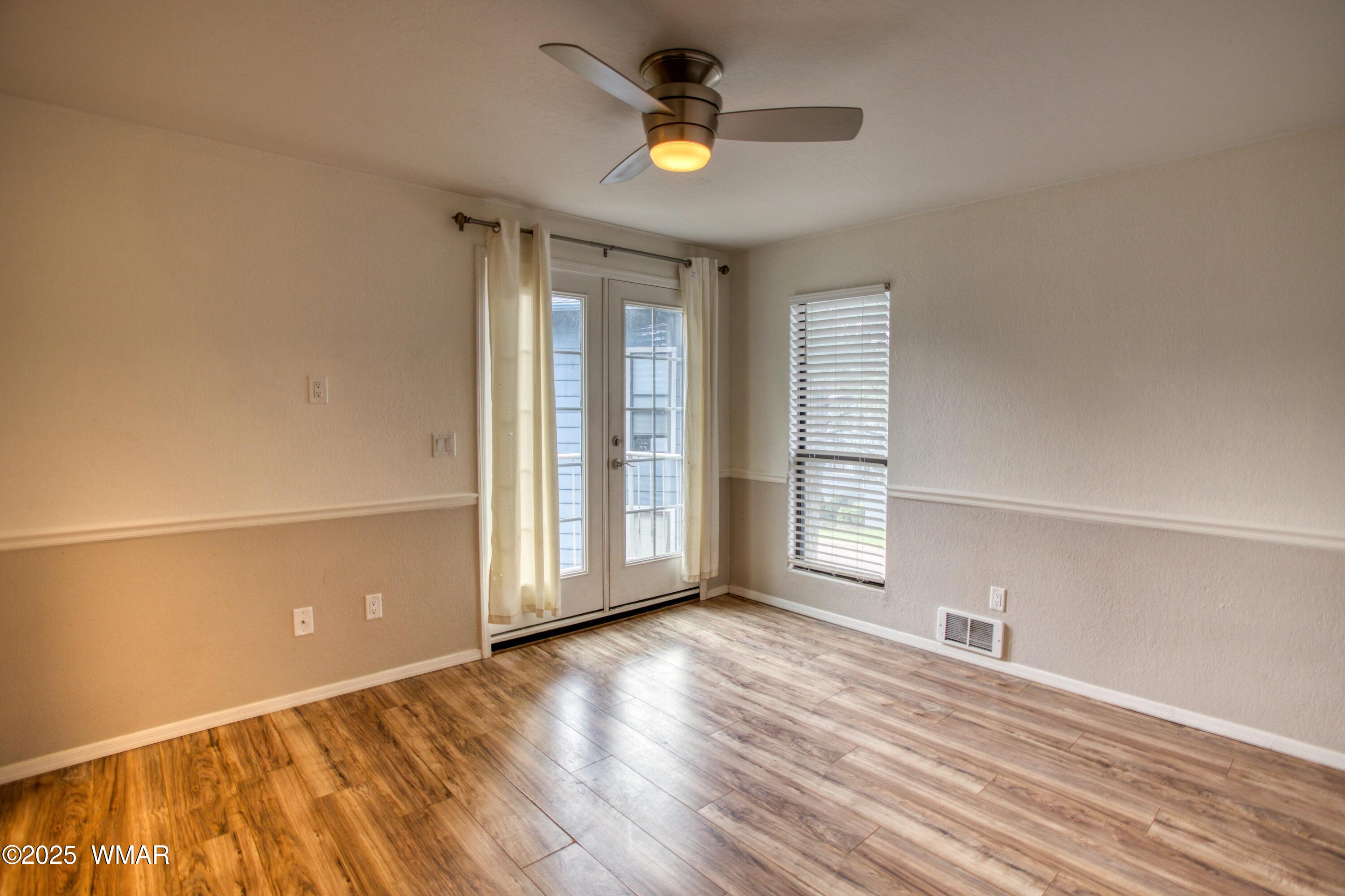 2700 South White Mountain Road, Unit 122 Show Low, AZ 85901 - Photo 18 of 25 wooden floor in an empty room with a window