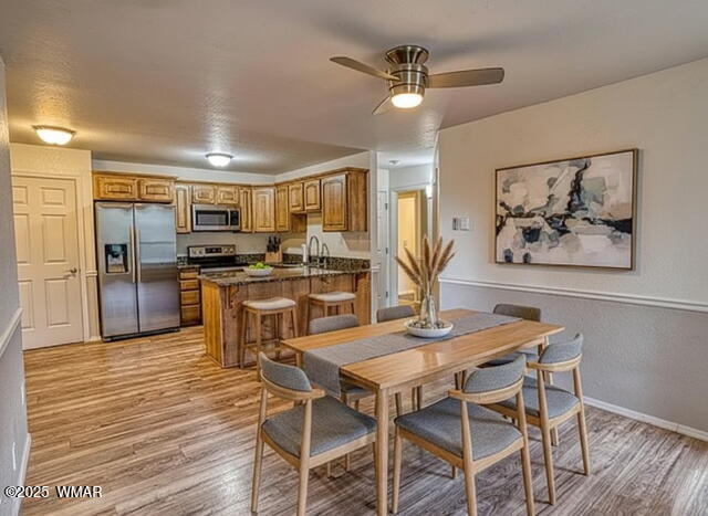 2700 South White Mountain Road, Unit 122 Show Low, AZ 85901 - Photo 3 of 25 a view of a dining room with furniture kitchen and wooden floor