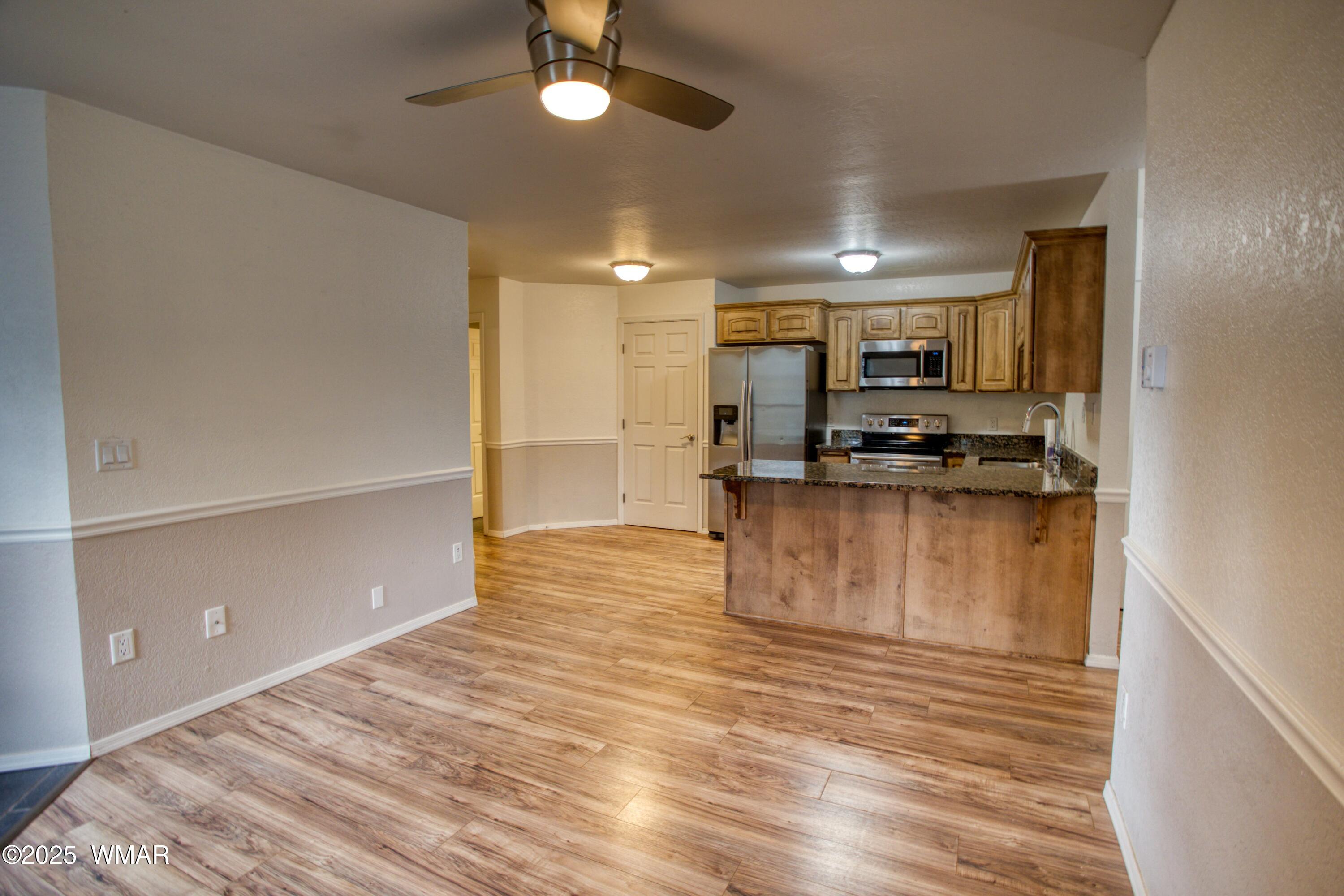 2700 South White Mountain Road, Unit 122 Show Low, AZ 85901 - Photo 5 of 25 a view of kitchen and refrigerator
