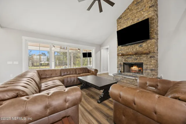 a living room with furniture and large windows
