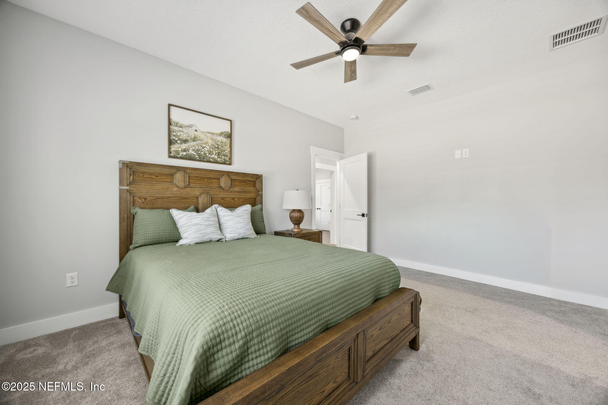 272272 Conner-Nelson Hilliard, FL 32046 - Photo 34 of 75 a bedroom with a bed and a chandelier