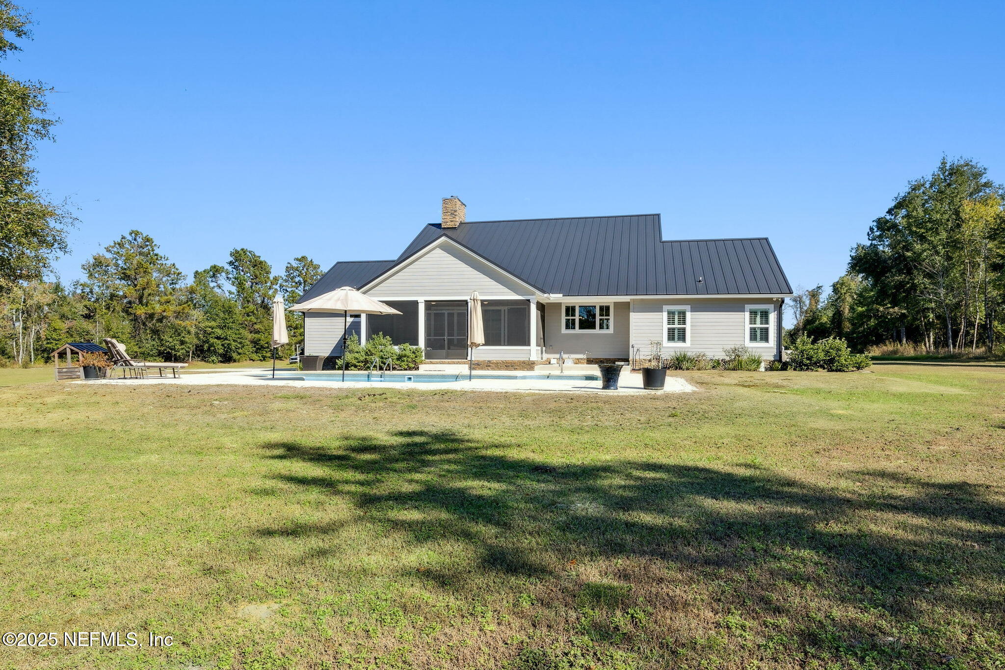 272272 Conner-Nelson Hilliard, FL 32046 - Photo 51 of 75 a front view of a house with swimming pool having outdoor seating