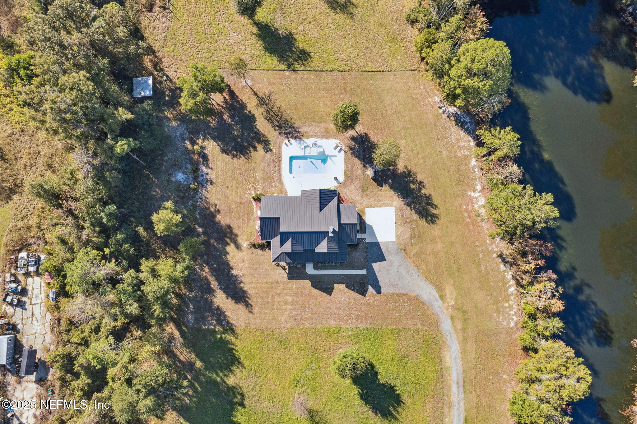 272272 Conner-Nelson Hilliard, FL 32046 - Photo 61 of 75 a aerial view of a house with swimming pool and large trees