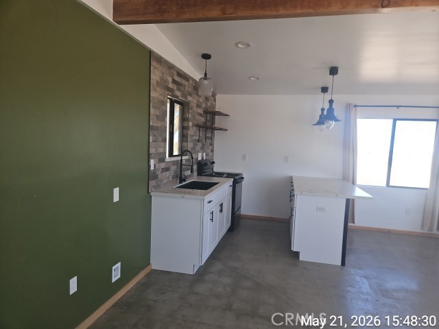 65154 Hoover Aka Mars St Road Joshua Tree, CA 92252 - Photo 5 of 11 a utility room with cabinets washer and dryer