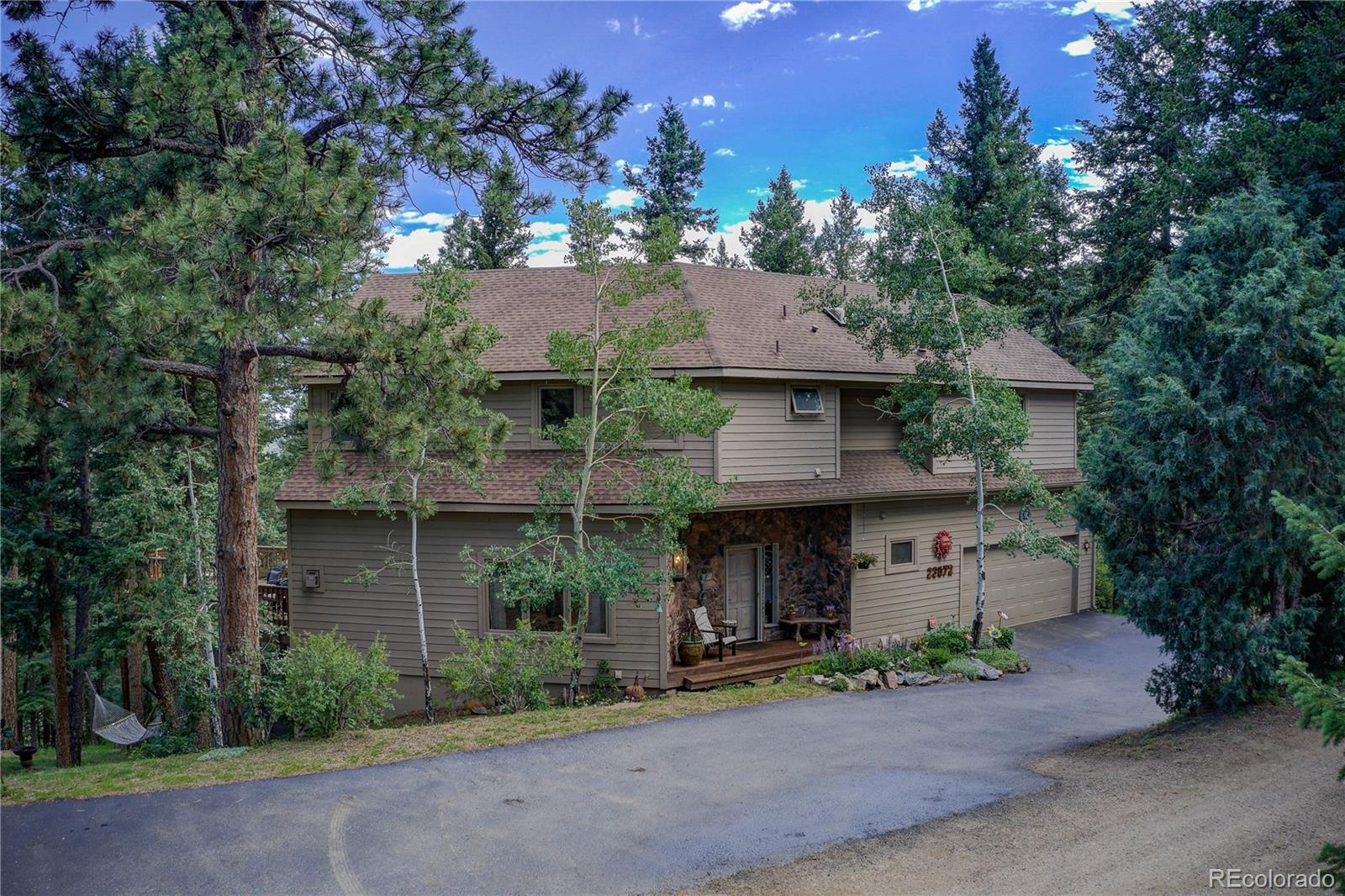23072 Pinecrest Road Golden, CO 80401 - Photo 1 of 34 a front view of a house with garden