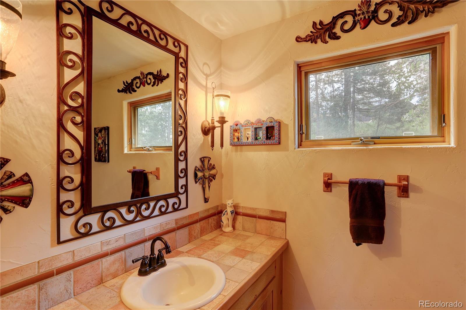 23072 Pinecrest Road Golden, CO 80401 - Photo 12 of 34 a bathroom with a sink and a mirror