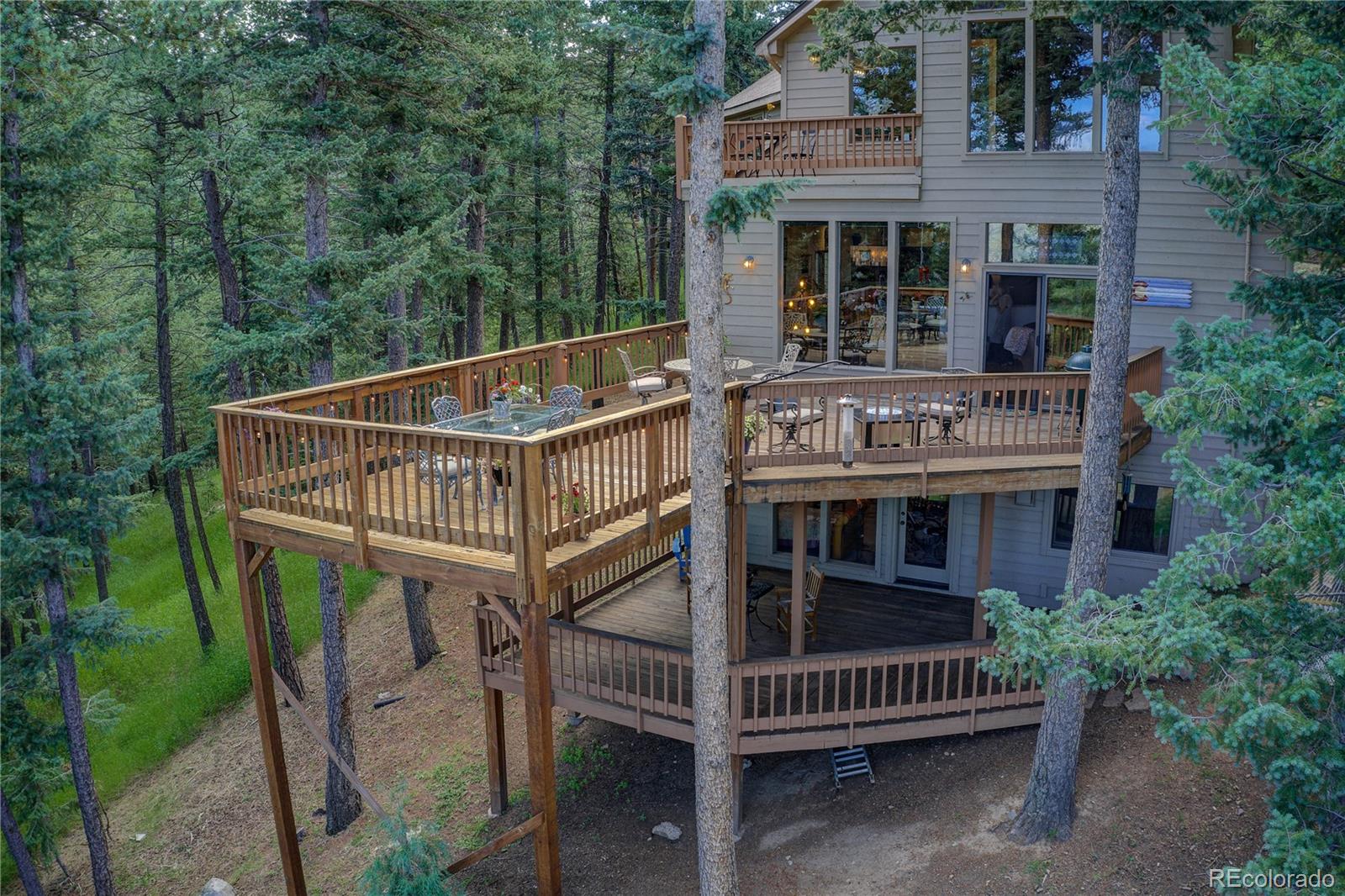 23072 Pinecrest Road Golden, CO 80401 - Photo 14 of 34 a view of a house with a deck and a yard