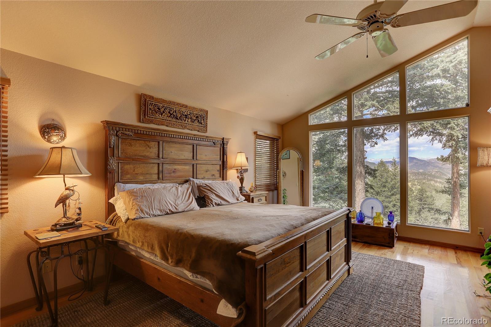 23072 Pinecrest Road Golden, CO 80401 - Photo 19 of 34 a bedroom with a bed and a night stand