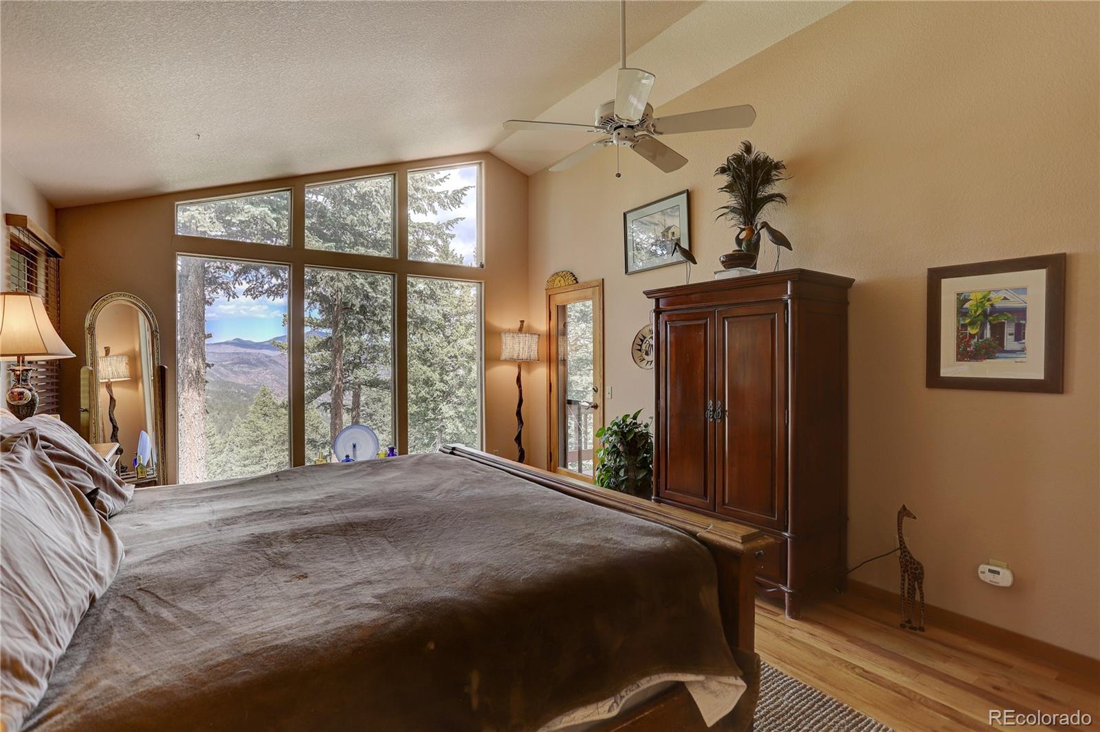 23072 Pinecrest Road Golden, CO 80401 - Photo 20 of 34 a bedroom with a bed next to a window with the outer view