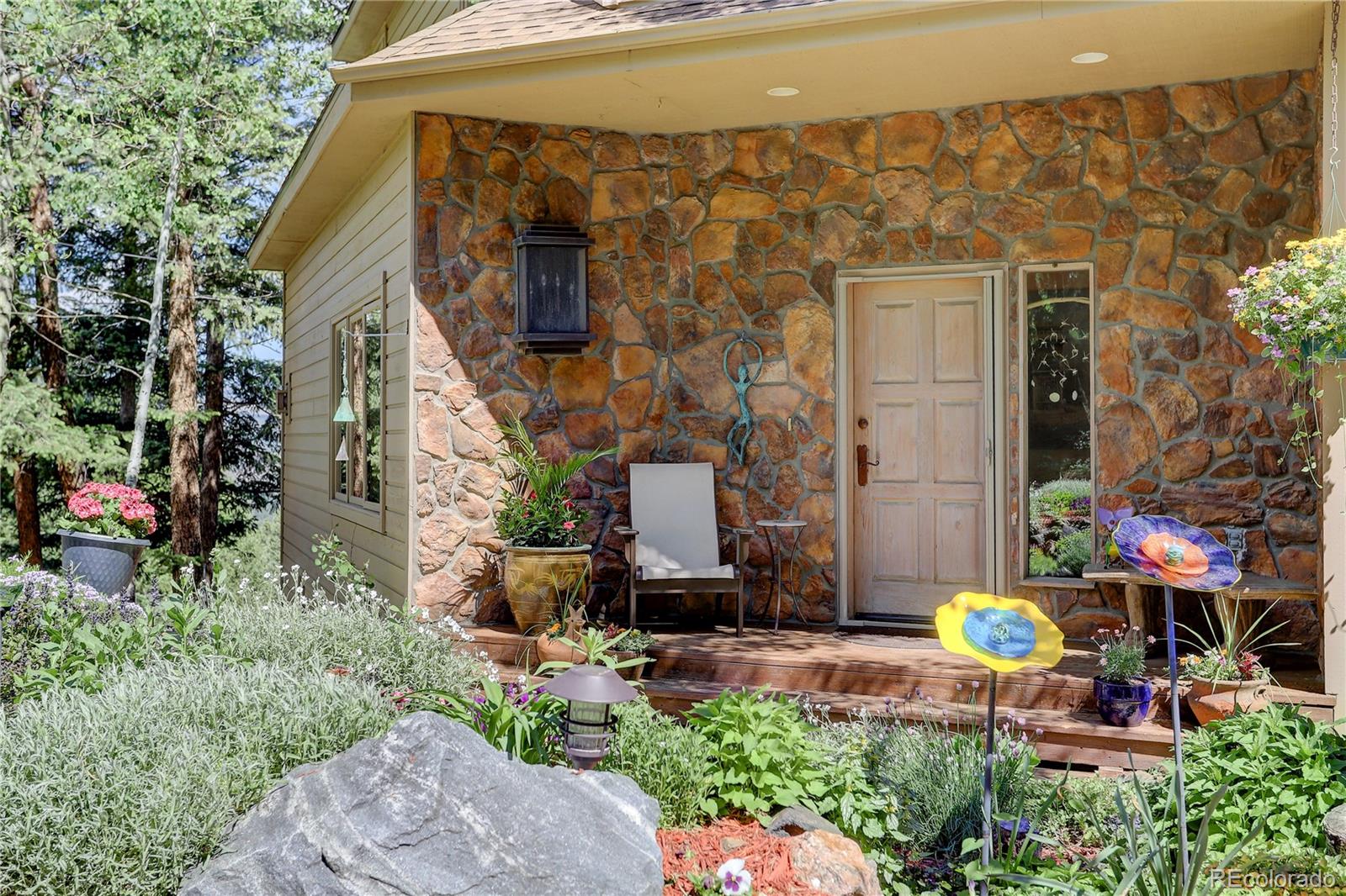 23072 Pinecrest Road Golden, CO 80401 - Photo 2 of 34 a backyard of a house with outdoor seating