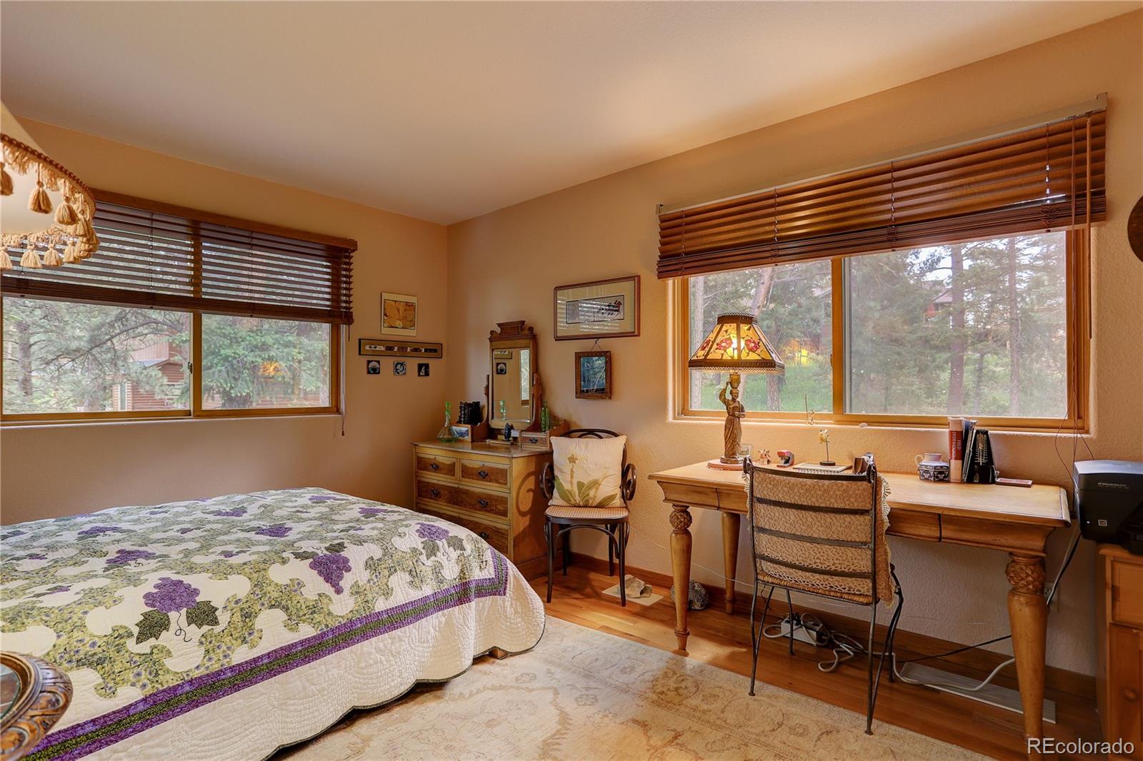 23072 Pinecrest Road Golden, CO 80401 - Photo 23 of 34 a bedroom with a bed and a large window