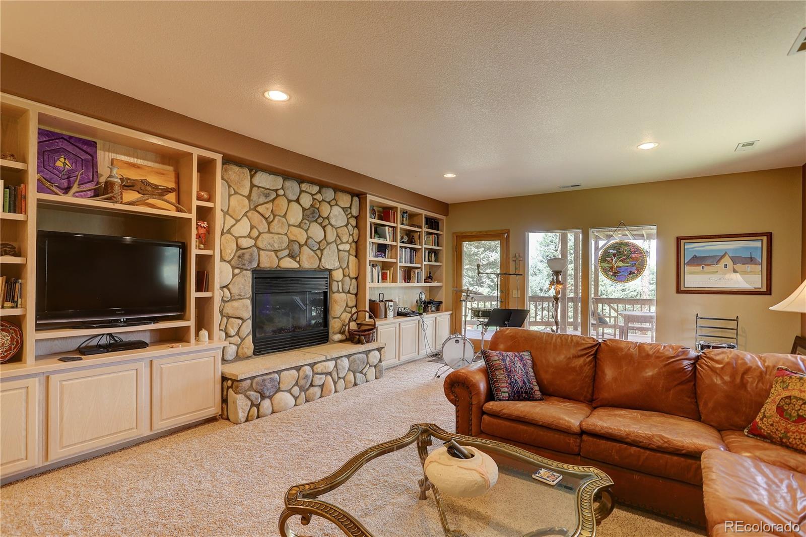 23072 Pinecrest Road Golden, CO 80401 - Photo 30 of 34 a living room with furniture and a flat screen tv