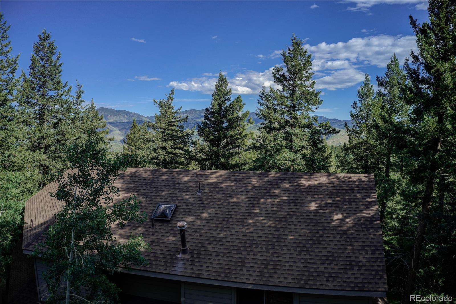 23072 Pinecrest Road Golden, CO 80401 - Photo 4 of 34 a view of a house with a tree