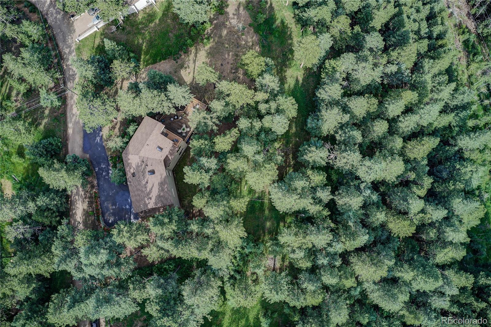 23072 Pinecrest Road Golden, CO 80401 - Photo 5 of 34 an aerial view of a house with a yard and large trees
