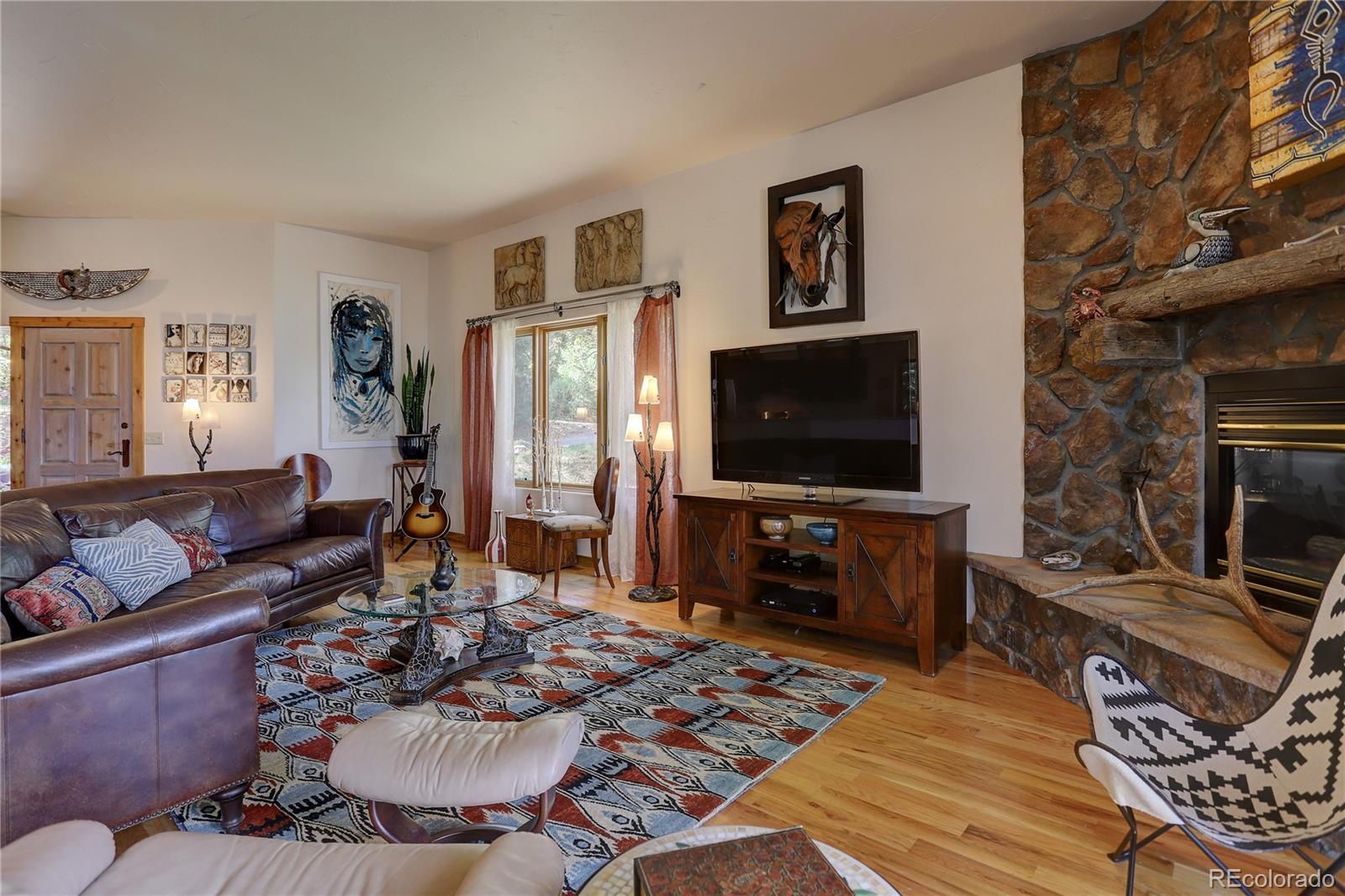 23072 Pinecrest Road Golden, CO 80401 - Photo 10 of 34 a living room with furniture and a flat screen tv