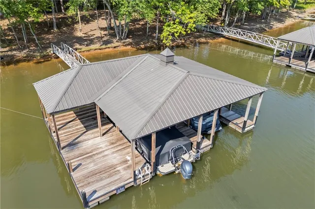 a backyard of a house with barbeque oven table and chairs