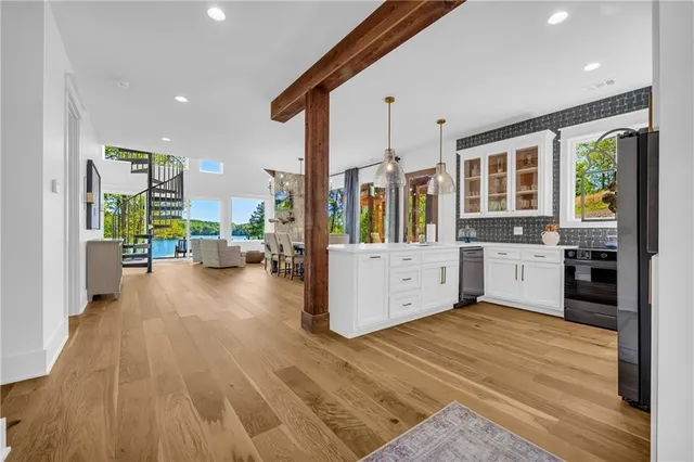 a dining room with stainless steel appliances granite countertop furniture and a chandelier