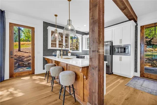 a kitchen with stainless steel appliances a refrigerator sink and cabinets