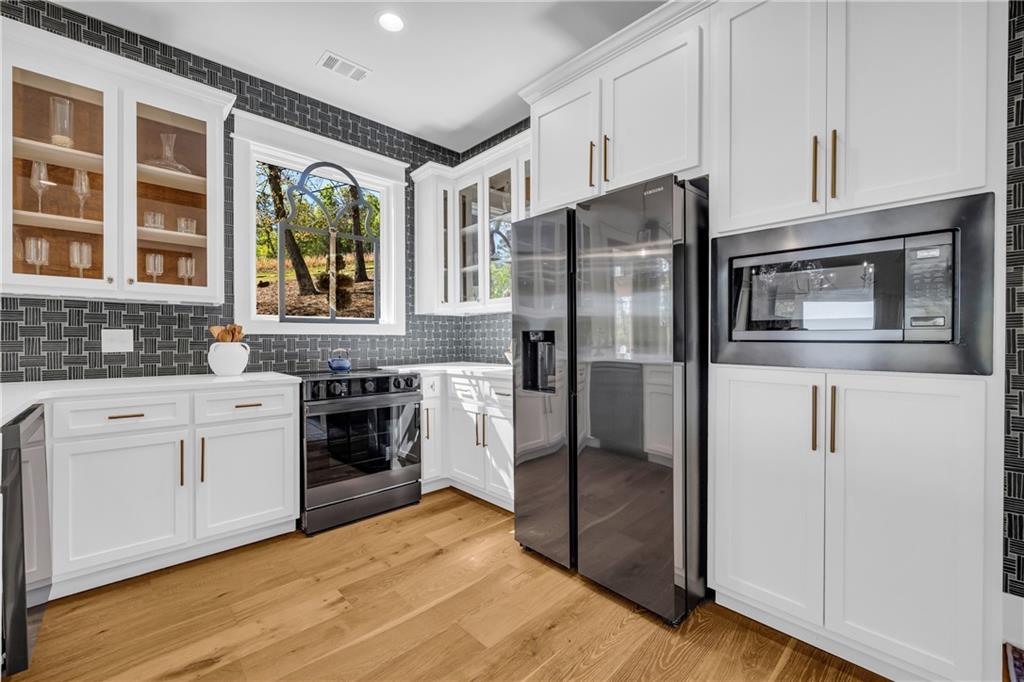 1132 Edgewater Trail Toccoa, GA 30577 - Photo 19 of 51 a kitchen with stainless steel appliances a refrigerator sink and cabinets