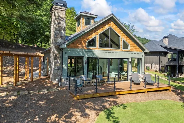 a view of a house with swimming pool and sitting area
