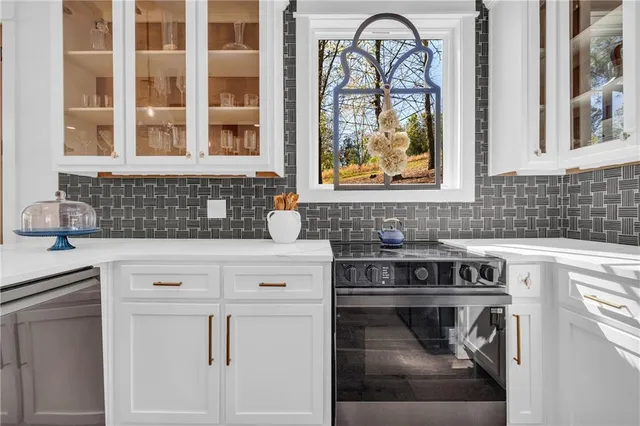 a kitchen with stainless steel appliances granite countertop a stove a sink and a refrigerator with wooden floor