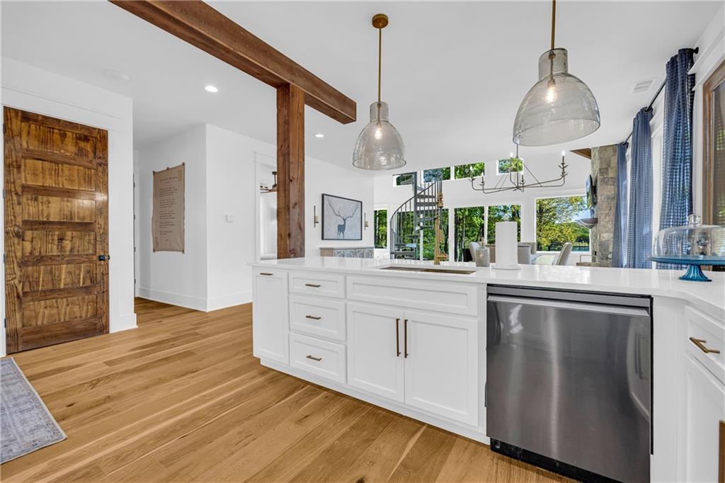 1132 Edgewater Trail Toccoa, GA 30577 - Photo 22 of 51 a kitchen with stainless steel appliances granite countertop a stove a sink and a refrigerator with wooden floor