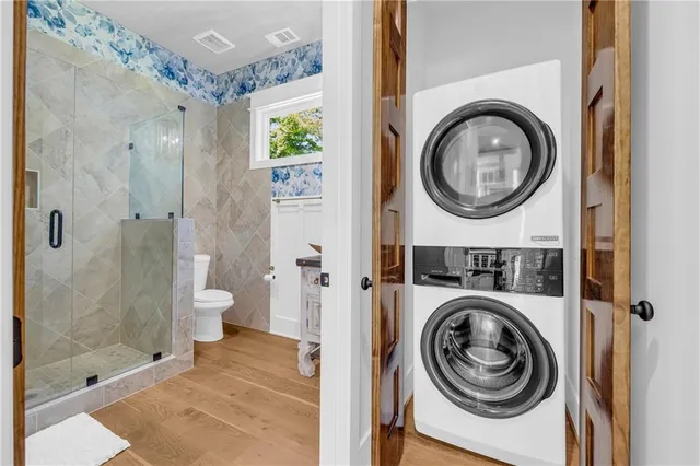 a white toilet sitting next to a bathroom shower