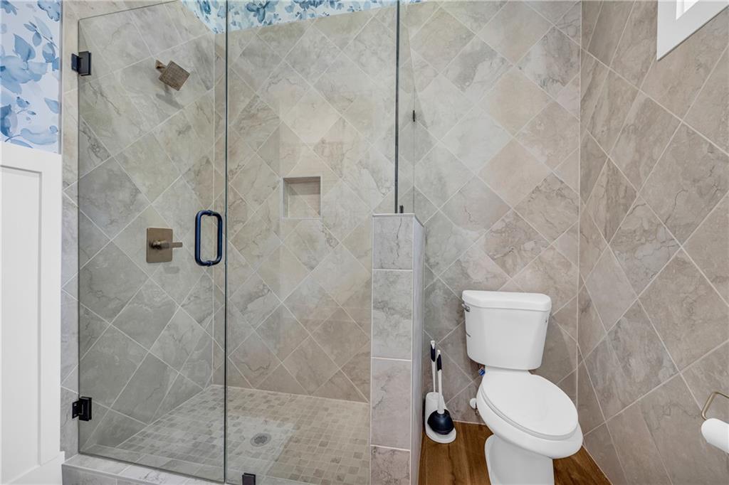 1132 Edgewater Trail Toccoa, GA 30577 - Photo 24 of 51 a white toilet sitting next to a bathroom shower