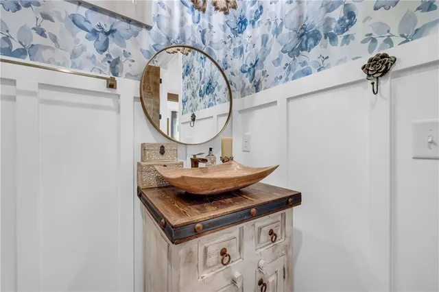 a bedroom with a bed a window and a chandelier