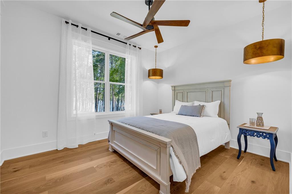 1132 Edgewater Trail Toccoa, GA 30577 - Photo 26 of 51 a bedroom with a bed a window and a chandelier