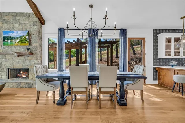 a dining room with stainless steel appliances granite countertop a couch and wooden floor