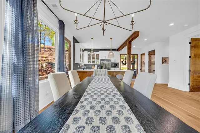 a view of a dining room with furniture wooden floor and a chandelier