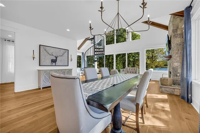 a living room with fireplace furniture and a large window