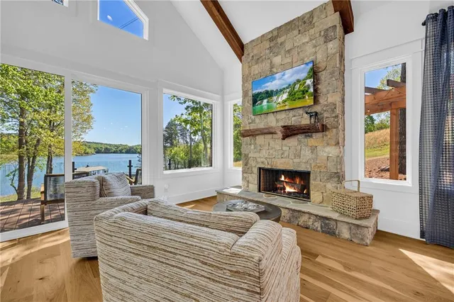 a living room with furniture large window and fireplace