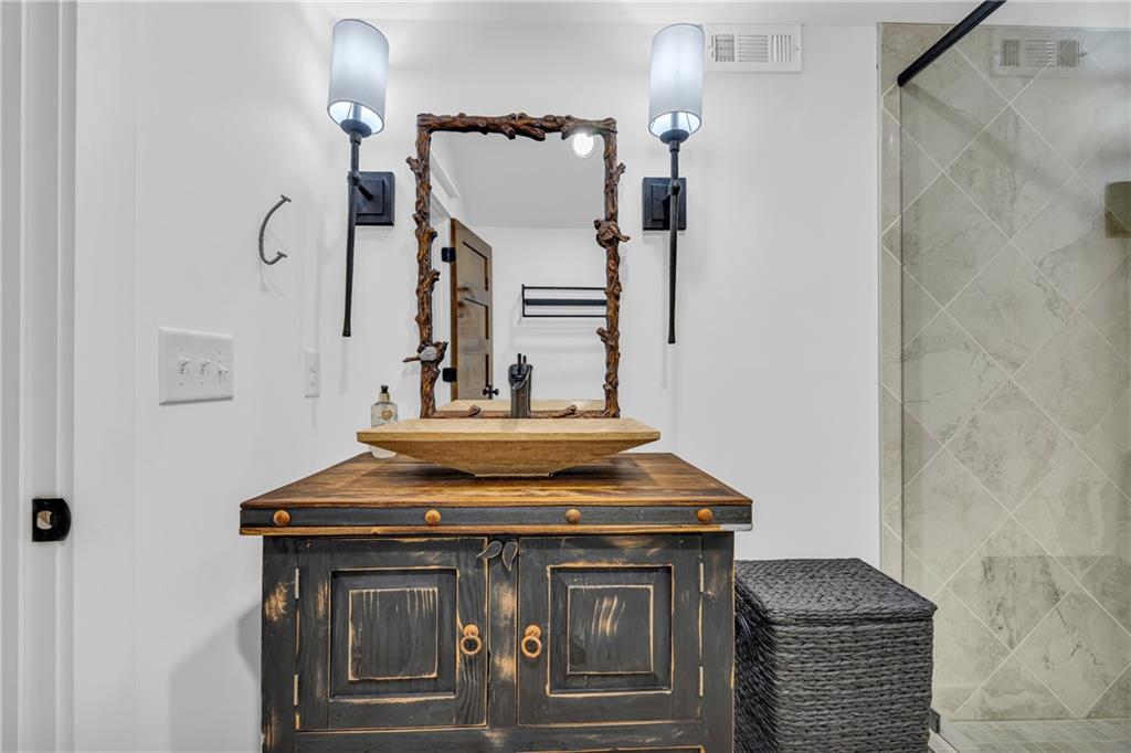 1132 Edgewater Trail Toccoa, GA 30577 - Photo 48 of 51 a view of bathroom with a sink and mirror