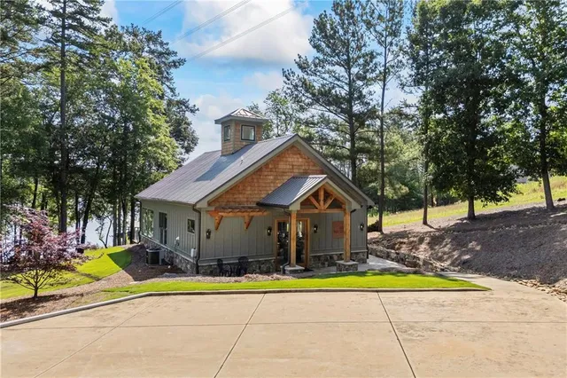 a house view with a swimming pool and of trees