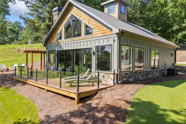 a view of house with backyard and outdoor seating