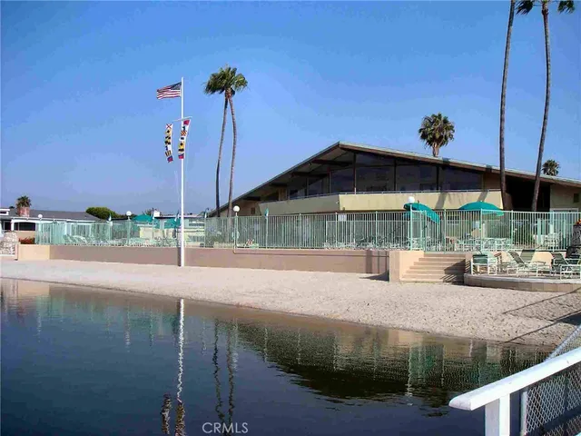 a view of house with a yard and sitting area